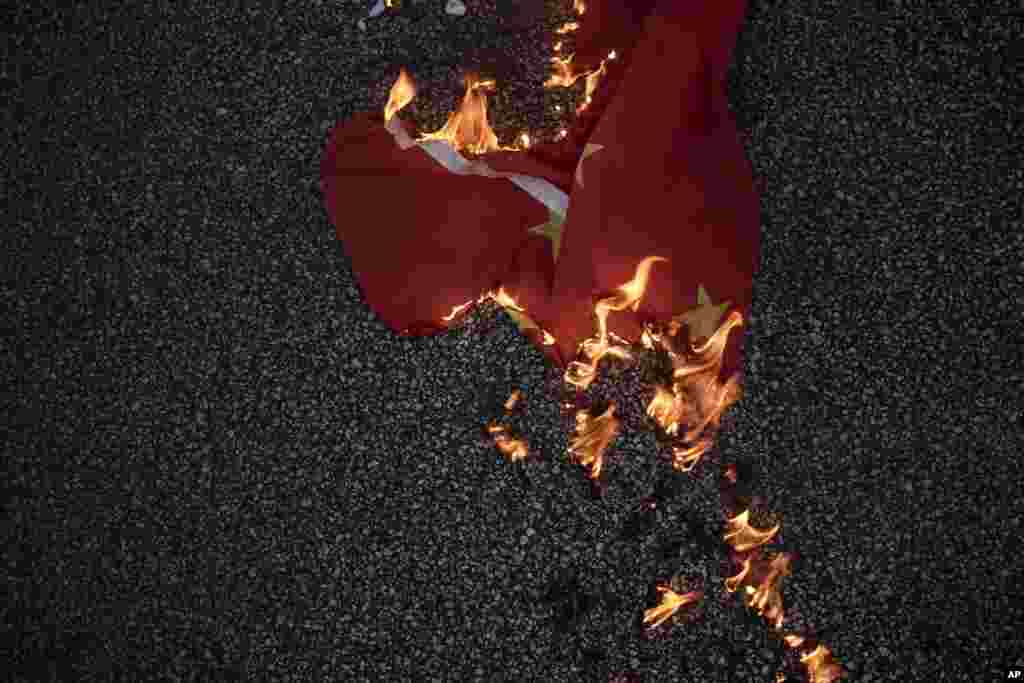 A Chinese national flag burns on the road in Hong Kong.