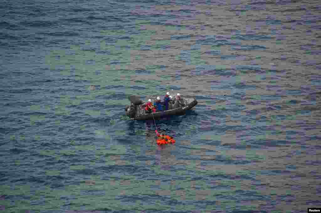 Crew members of Japan’s Fisheries Agency rescue North Korean crew members of a fishing vessel that sank after colliding with a Japanese patrol boat, in the Yamato Shallows, about 400 kilometers off the western coast of Japan. (Image provided by Japan Coast Guard. 9th Regional Coast Guard Headquarters) 