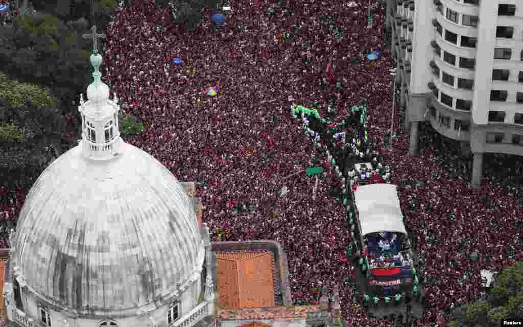 Brazil's Flamengo football team celebrate their victory with fans during a parade in Rio de Janeiro, after the team defeated Argentina's River Plate in the Copa Libertadores final football match in Lima, Peru.