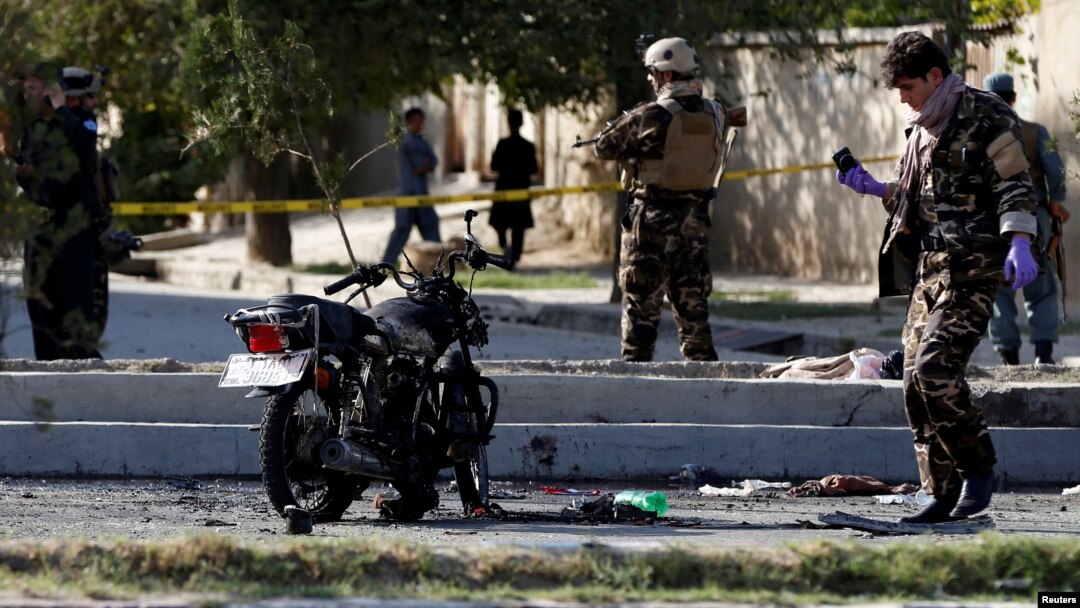 FILE - Afghan security forces inspect the site of a suicide attack in Kabul, Afghanistan Sept. 9, 2018.