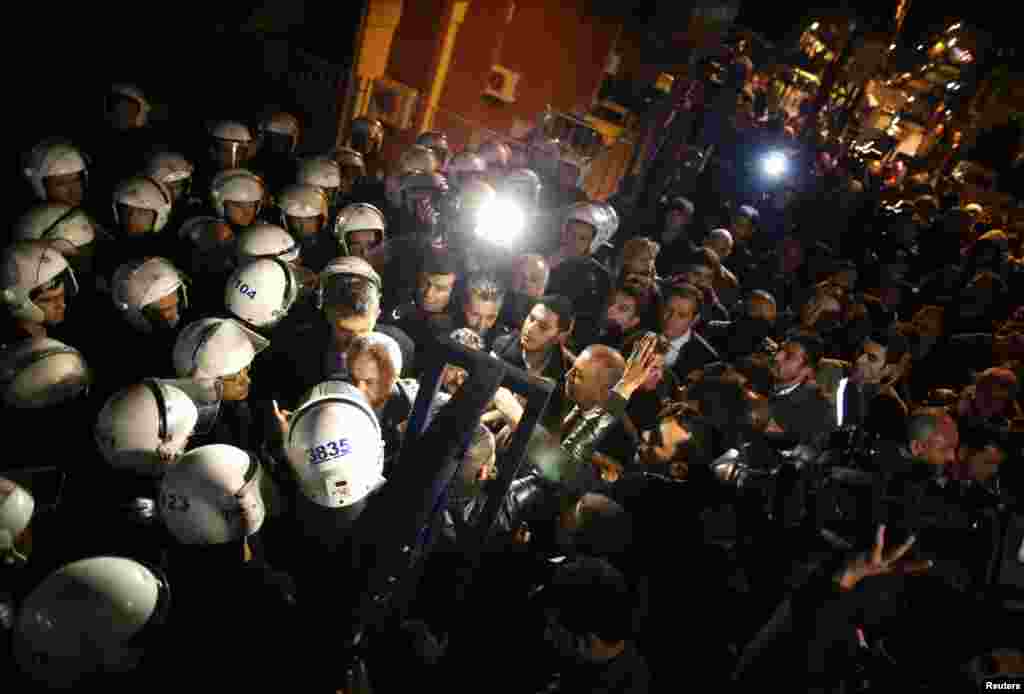 Gursel Tekin (center), the deputy chairman of the main opposition Republican People's Party (CHP) arrives at Cankaya Election Committee, a local ballot collection center, in Ankara, March 31, 2014.