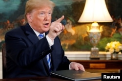 FILE - U.S. President Donald Trump speaks to reporters after signing a proclamation declaring his intention to withdraw from the JCPOA Iran nuclear agreement in the Diplomatic Room at the White House in Washington, May 8, 2018.
