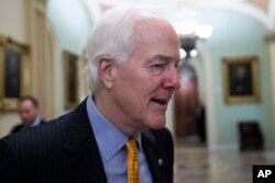 FILE - Senate Majority Whip Sen. John Cornyn, R-Texas, talks with reporters on Capitol Hill, Oct. 11, 2018 in Washington.