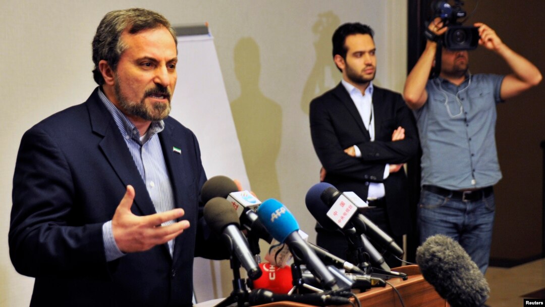 Louay al-Safi, spokesman for the Syrian National Coalition (L), speaks during a news conference in Istanbul May 26, 2013. 