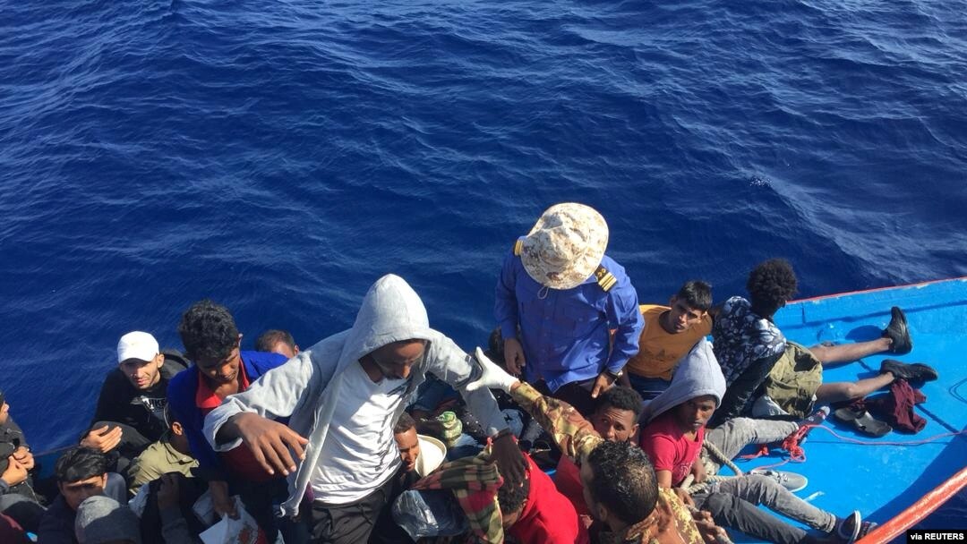 FILE - Migrants in a dinghy are rescued by the Libyan coast guard in the Mediterranean Sea off the coast of Libya, Oct. 18, 2019. 