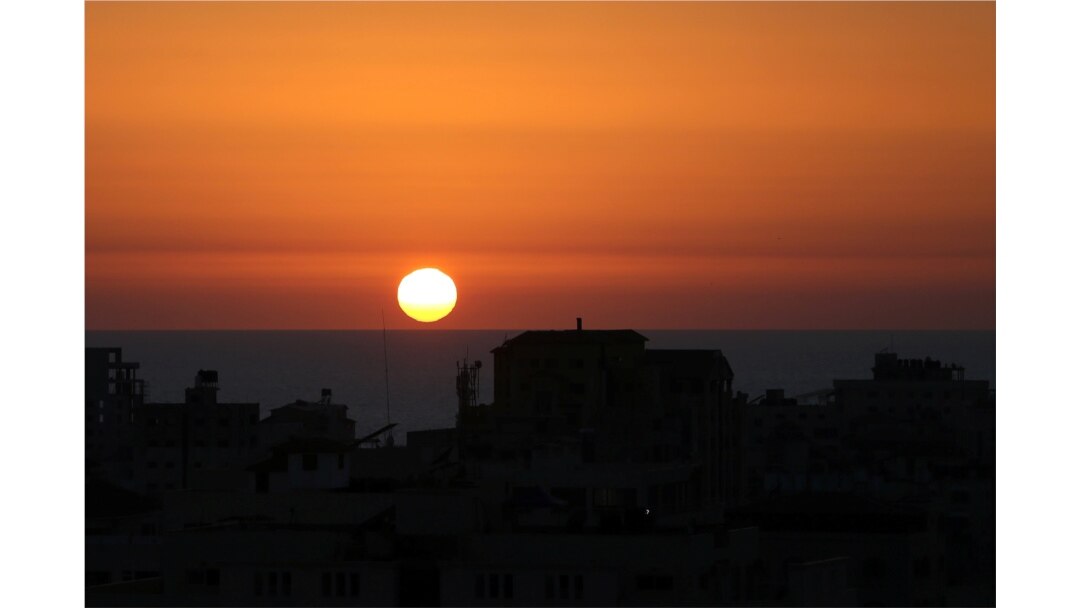 The sun sets over the Mediterranean Sea off the coast of Gaza City as cross-border violence between the Israeli military and Palestinian militants continues, May 14, 2021.