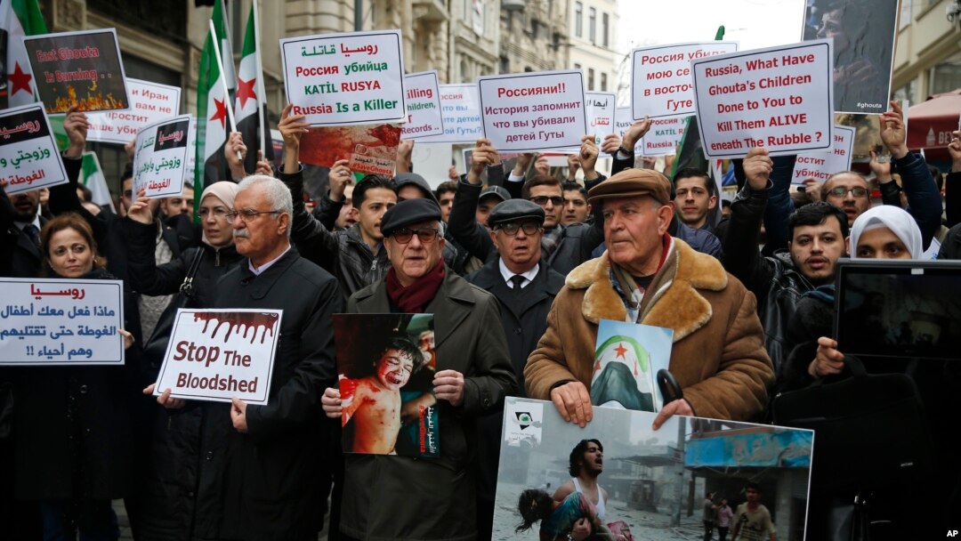 Syrians, including prominent opposition figures, protesting attacks on rebel-held suburb of eastern Ghouta in Syria's capital Damascus, gather during a rally outside the Russian Consulate in Istanbul, Thursday, Feb. 22, 2018. 