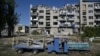 This photograph shows an abandoned playground next to a heavily damaged building in the city of Pokrovsk, Donetsk region, September 24, 2024, amid Russia's invasion of Ukraine.