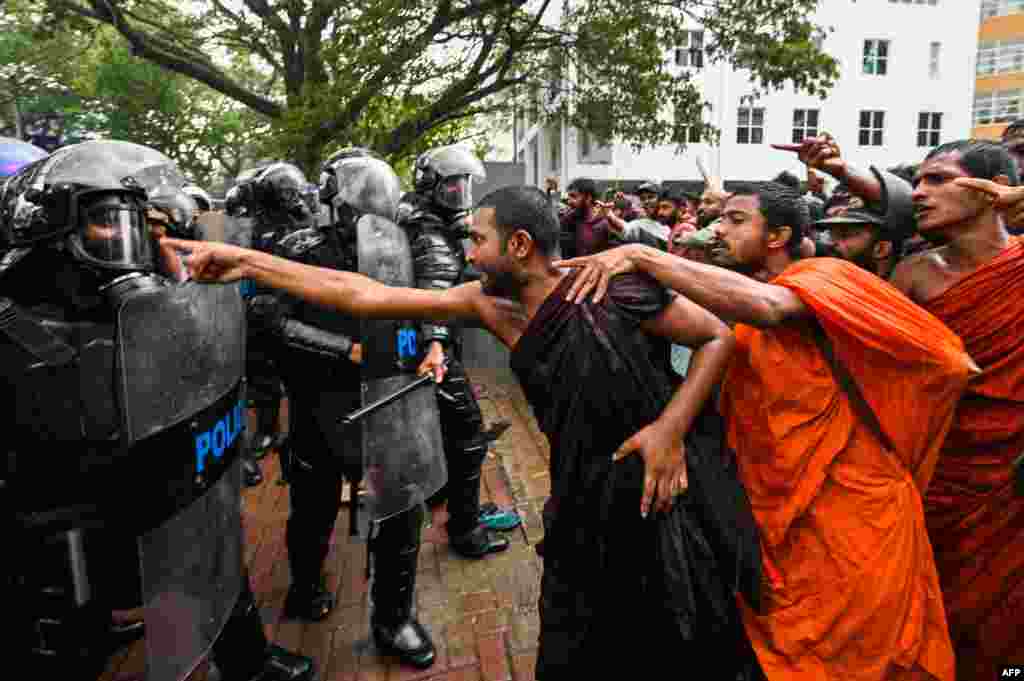 Anti-government demonstrators and university students scuffle with police during a protest demanding the release of Inter University Students' Federation leader Wasantha Mudalige, in Colombo. 