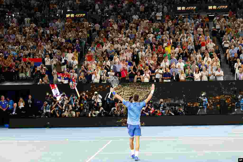 Novak Djokovic of Serbia celebrates after defeating Tommy Paul of the U.S. in their semifinal at the Australian Open tennis championship in Melbourne, Australia.