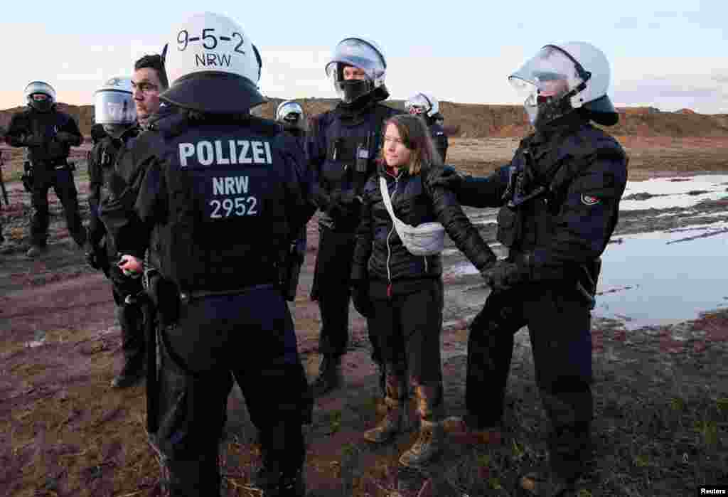 Police officers detain climate activist Greta Thunberg during a protest against the expansion of the Garzweiler open-cast lignite mine of Germany's utility RWE to Luetzerath, in Germany.