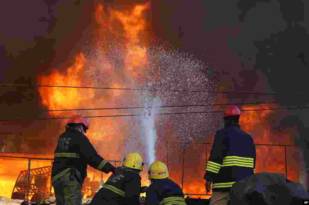 Firefighters work to douse a fire that broke out in a five-story commercial building in Hyderabad, India.