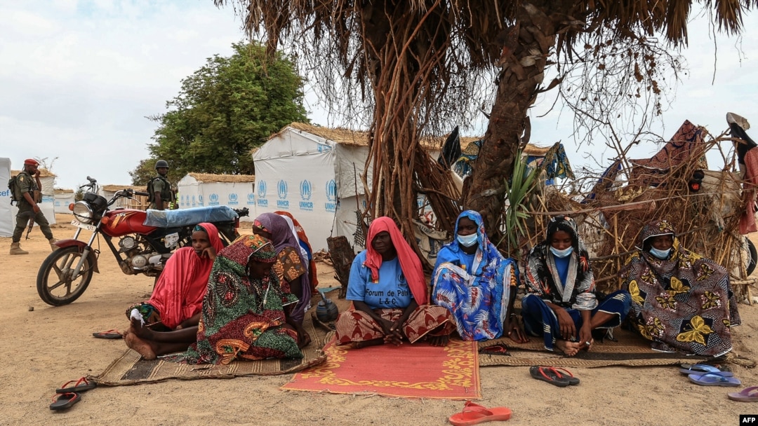 FILE - A group of women take shelter under a tree a the Bogo IDP camp in Maroua, Cameroon, April 28, 2022.