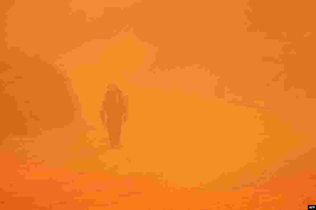 A hotshot firefighter walks through smoke as the Line Fire burns over 43,000 acres near Big Bear Lake in San Bernardino County, California, Sept. 30, 2024.