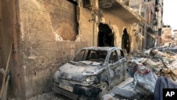 Rubble lines a street in Douma, the site of a suspected chemical weapons attack, near Damascus, Syria, on April 16, 2018. (Hassan Ammar/AP)
