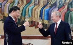 Russian President Vladimir Putin and Chinese President Xi Jinping attend a reception at the Kremlin in Moscow on March 21, 2023. (Pavel Byrkin/Sputnik//Kremlin/ via Reuters