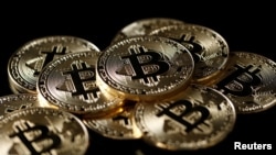 A collection of Bitcoin (virtual currency) tokens are displayed in this illustration taken Dec. 8, 2017.