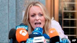 FILE - Adult film actress Stormy Daniels addresses reporters outside federal court in New York, April 16, 2018.
