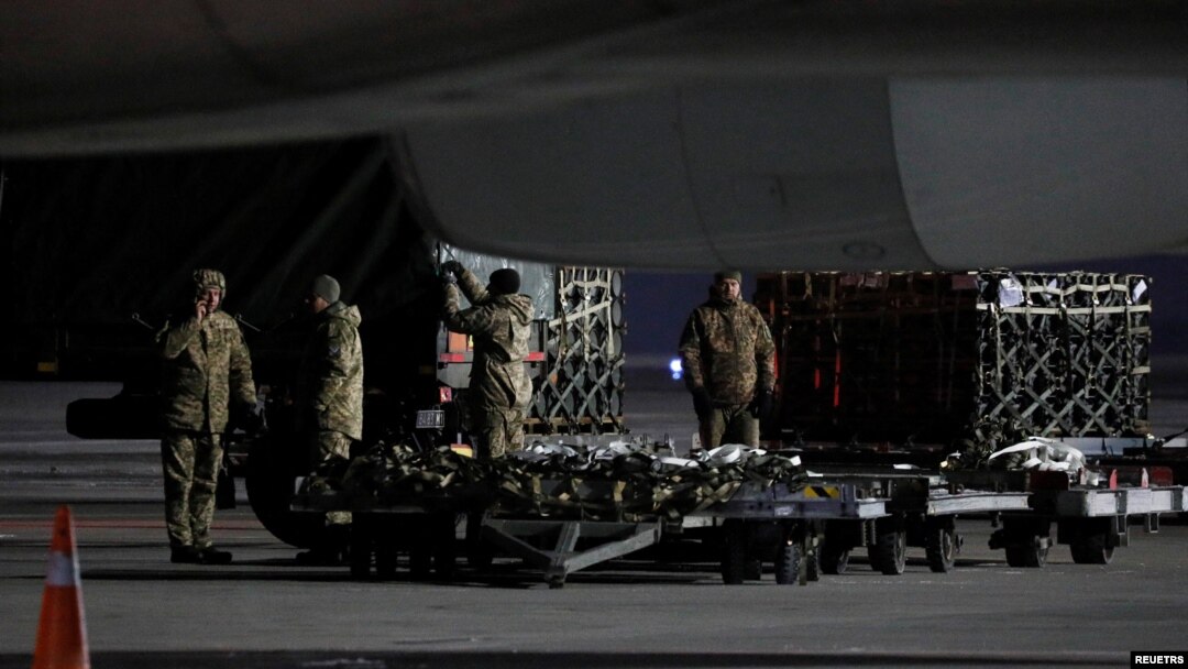 Ukrainian service members unload a shipment of military aid delivered as part of the United States of America's security assistance to Ukraine, at the Boryspil International Airport outside Kyiv, Ukraine, Jan. 25, 2022. 