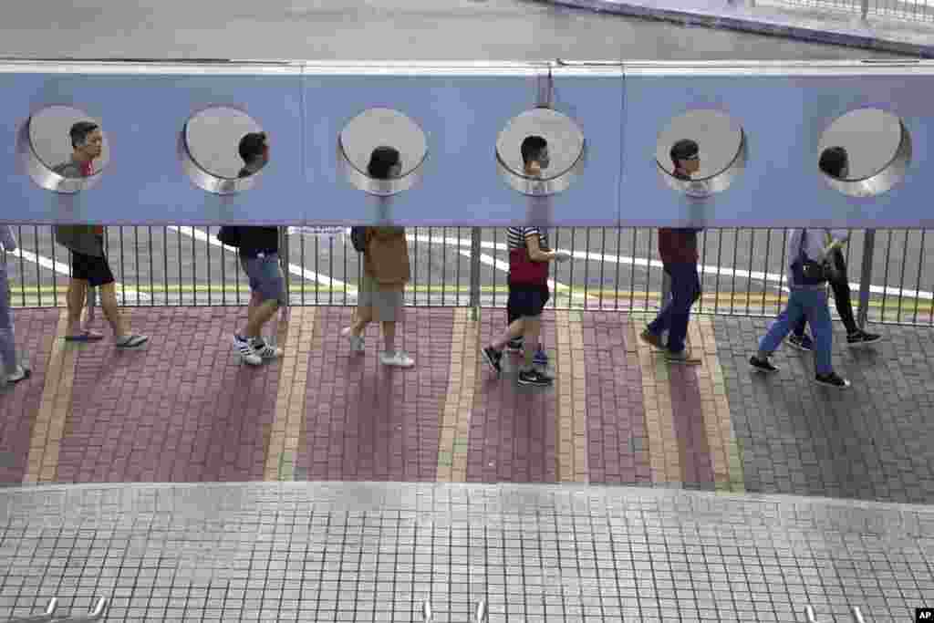 People line up to vote outside of a polling place in Hong Kong.