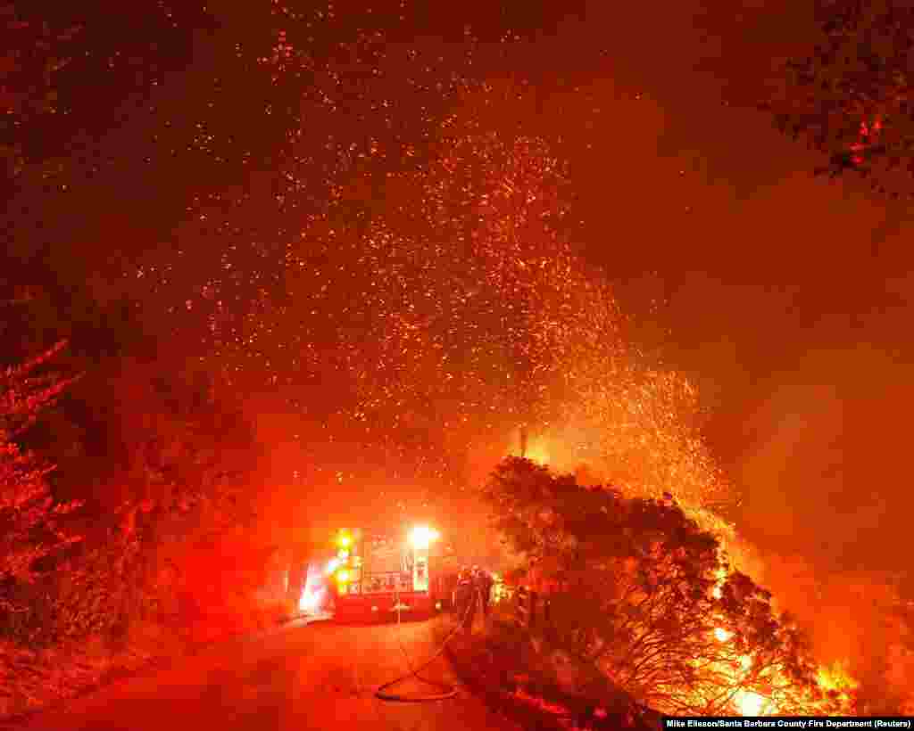 Firefighters battle flames off Highway 154 north of Santa Barbara, California, Nov. 25, 2019, in this picture obtained from social media.