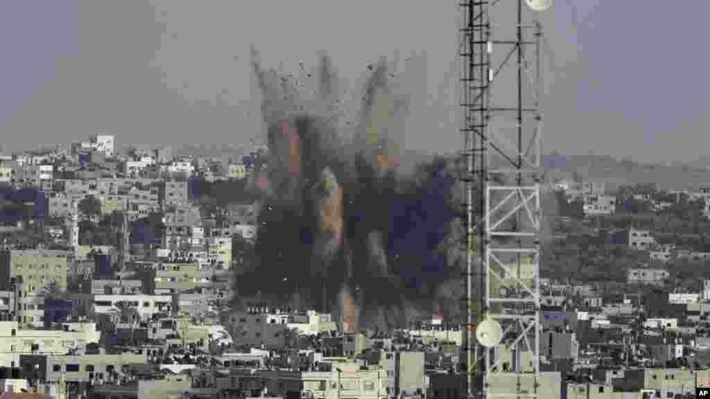 Smoke, dust and derbies rise after an Israeli strike in Gaza City in the northern Gaza Strip, Aug. 10, 2014.