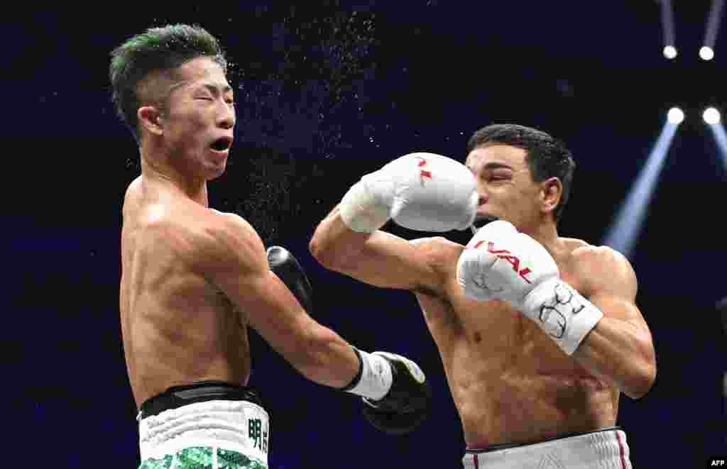 Nordine Oubaali of France (R) fights with of Japan's Takuma Inoue during their WBC bantamweight title boxing match at Saitama Super Arena in Saitama, Japan.