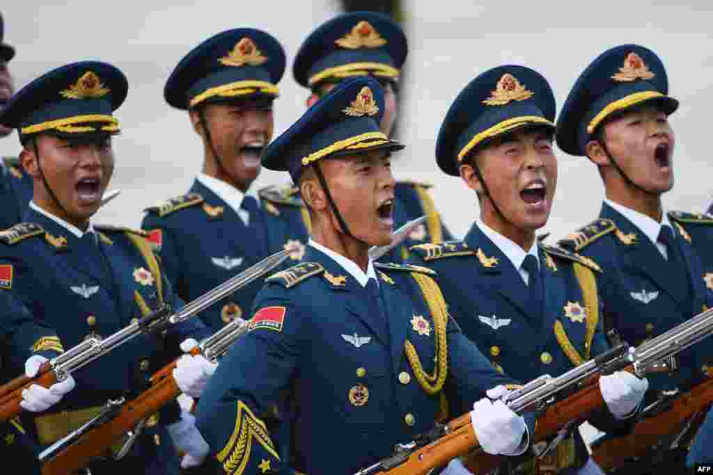 Members of a military honor guard parade during a welcome ceremony for Uzbekistan's Prime Minister Abdulla Aripov (not seen) outside the Great Hall of the People in Beijing, China.