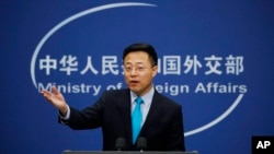 Chinese Foreign Ministry new spokesman Zhao Lijian gestures as he speaks during a daily briefing at the Ministry of Foreign Affairs office in Beijing, Feb. 24, 2020. 
