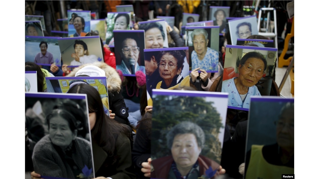 FILE - Students hold portraits of deceased former South Korean "comfort women" during a weekly anti-Japan rally in front of the Japanese Embassy in Seoul, South Korea.