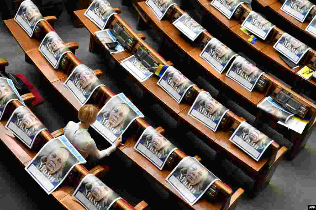 A deputy reads a special edition of the newspaper "Dzerkalo Tyzhnia" dedicated to mothers of Ukrainian servicemen who died in the battle with Russia-backed separatists, before the solemn opening and first sitting of the new parliament in Kyiv.