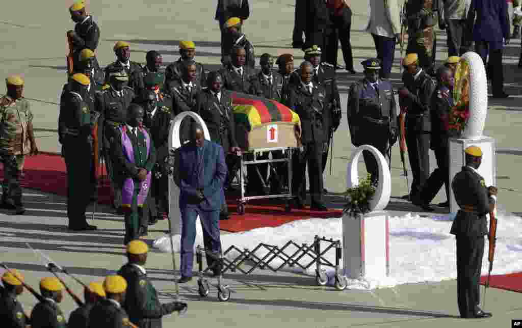 A coffin carrying the body of Zimbabwe's former ruler Robert Mugabe arrives from Singapore, at the RG Mugabe International Airport in Harare. The body of Mugabe will be displayed at historic locations for several days before burial at a location that is still to be determined.