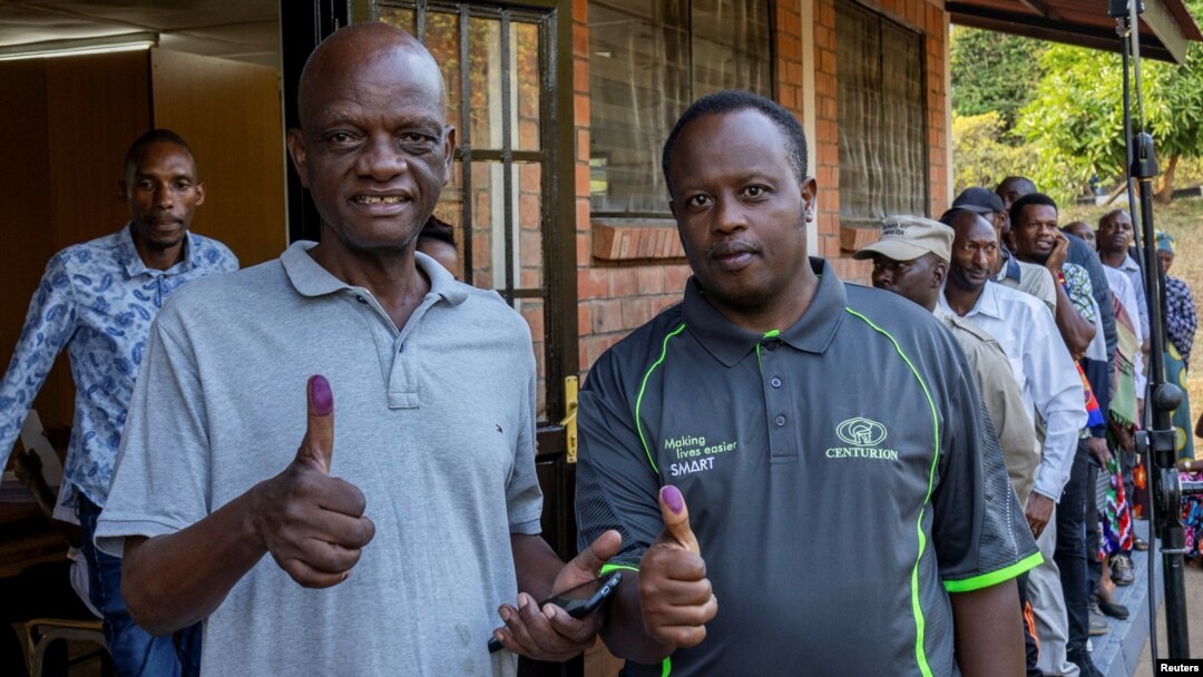 Voters show their inked fingers to the media after casting their ballots at polling centre during the presidential election in Kigali, Rwanda ,July 15, 2024.