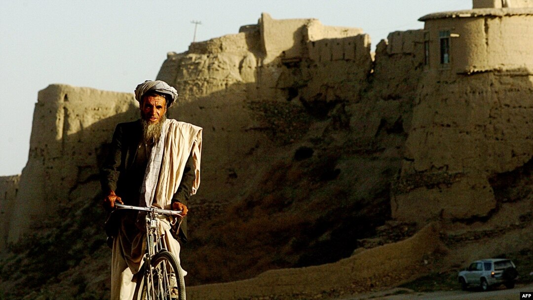 An Afghan man rides his bicycle through an old city area of Ghazni province, August 20, 2007. (Click to Expand)