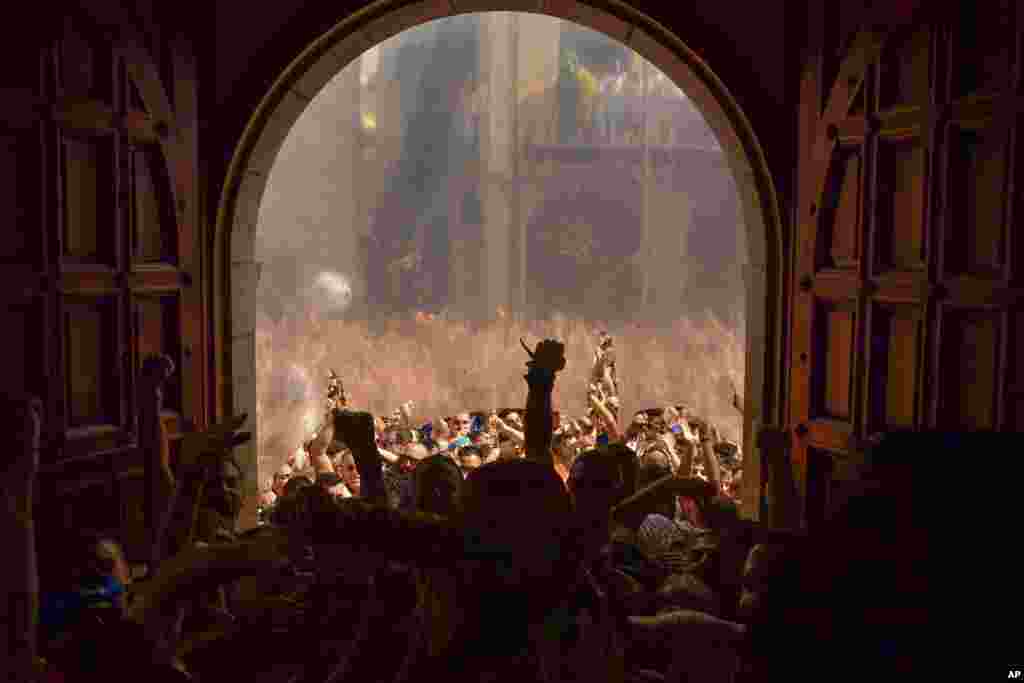 Revelers enter in City Hall at the end of the 'Cipotegato', in the small village of Tarazona, northern Spain.