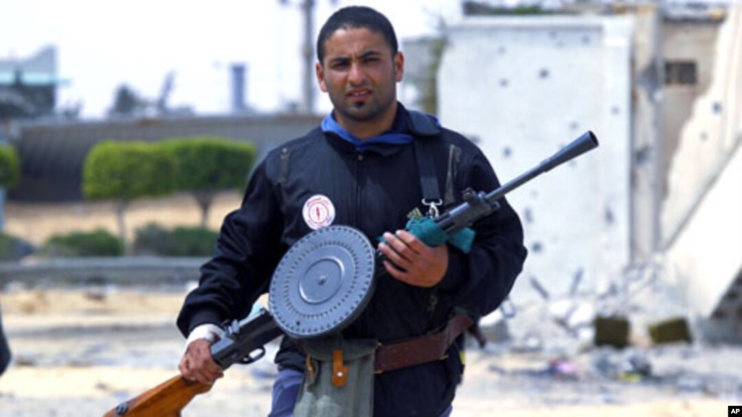 A rebel fighter takes position in the frontline at Tripoli street in Misrata. Tripoli street is the scene of some of the heaviest fighting between rebels and Gaddafi forces, April 21, 2011
