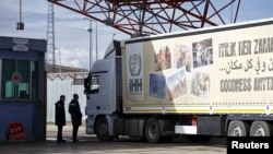 FILE - An aid truck enters Syria from Turkey at Turkey's Oncupinar border crossing on the Turkish-Syrian border in the southeastern city of Kilis, Turkey, Feb. 7, 2016.
