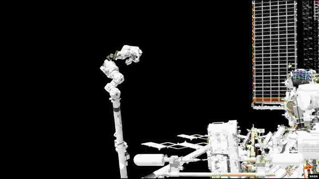 Station Commander Luca Parmitano of the European Space Agency conducts repairs while attached to the space station’s robotic arm during the first spacewalk to repair the Alpha Magnetic Spectrometer, Nov. 15, 2019.