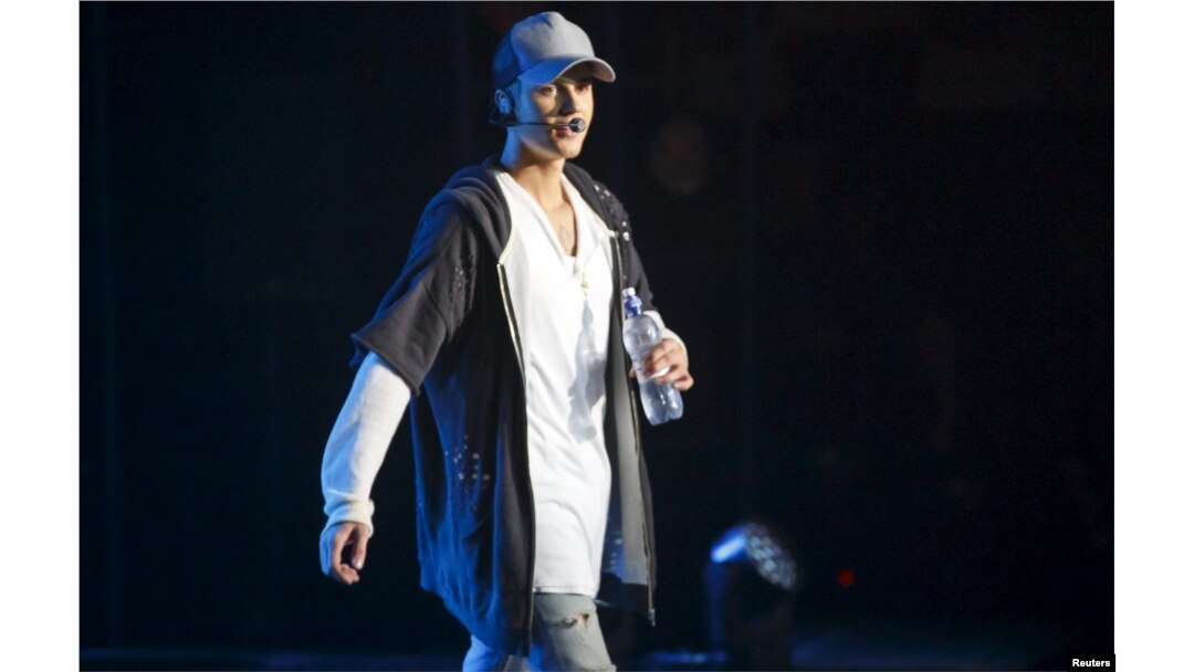 Singer Justin Bieber walks on stage during a concert in Oslo, Oct. 29, 2015.
