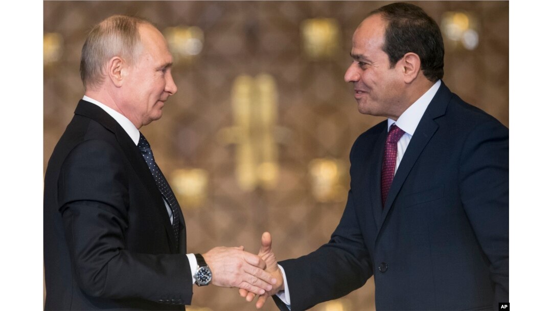 Russian President Vladimir Putin, left, Egyptian President Abdel-Fattah El-Sissi, shake hands after a news conference following their talks in Cairo, Egypt, Dec. 11, 2017.