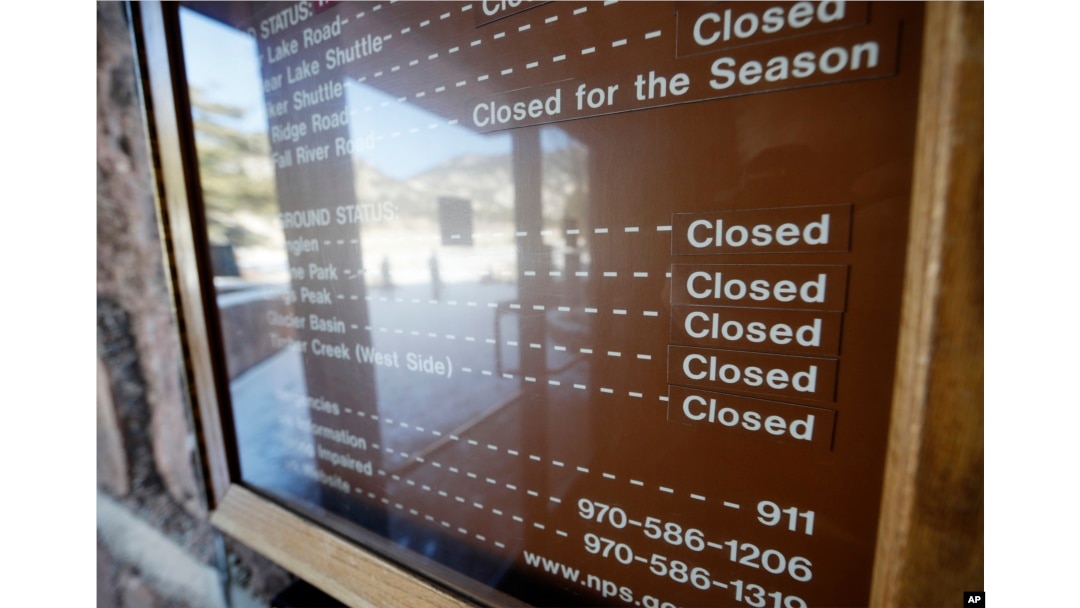 A sign inside the main visitors center notes that campgrounds are closed at Rocky Mountain National Park, Dec. 22, 2018, in Estes Park, Colo., because of a partial federal shutdown.