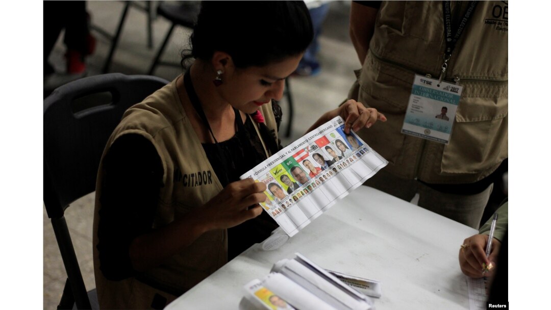 A woman takes part in a hand count of some of the votes cast in Honduras' recent presidential election in Tegucigalpa, Dec. 7, 2017.