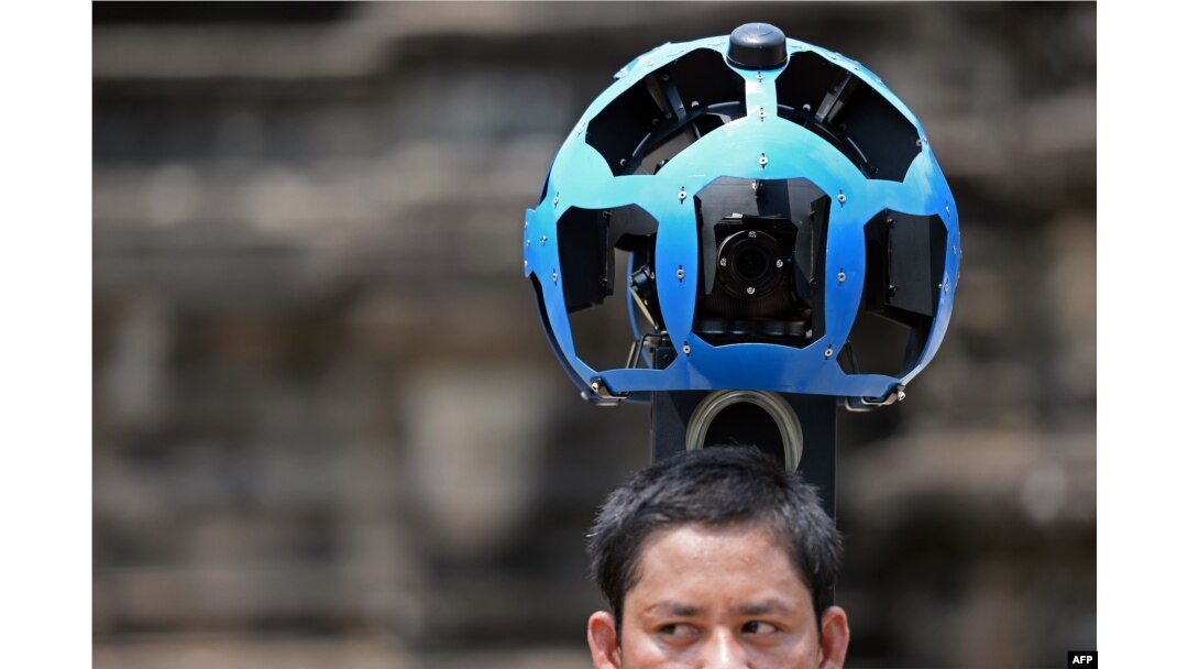A Cambodian technician carries a back-packa mounted with a device housing 15 cameras as he demonstrates the technique used to digitally map the Angkor Wat temple, part of the Angkor architectural complex in north-western Cambodia on April 3, 2014.