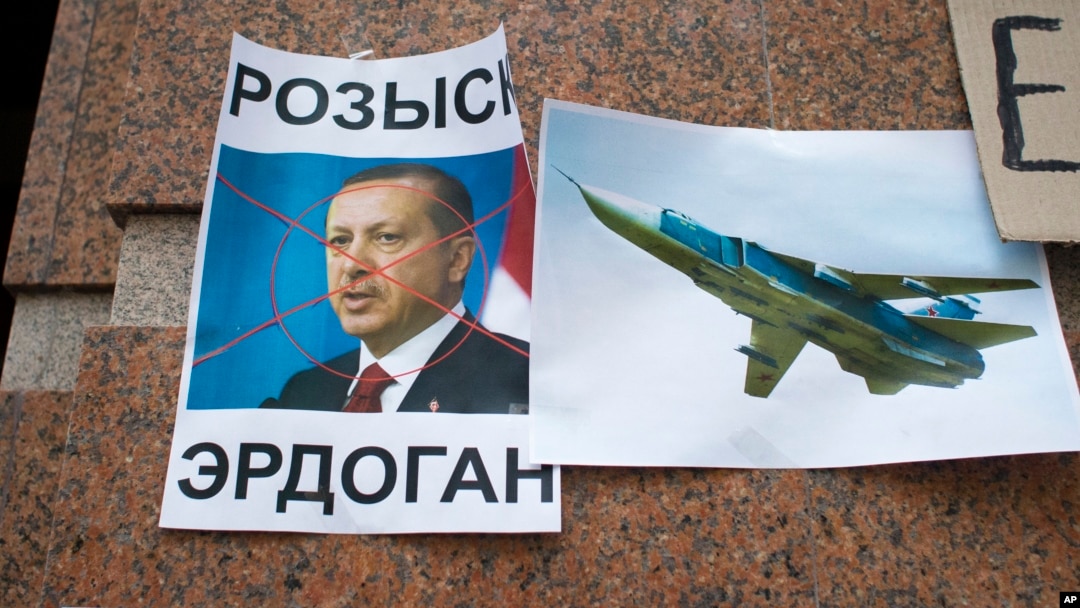 A poster displaying a portrait of Turkish President Recep Tayyip Erdogan and reading "Wanted," is left after a protest at the Turkish Embassy in Moscow, Nov. 25, 2015, following Turkey's downing of a Russian warplane.