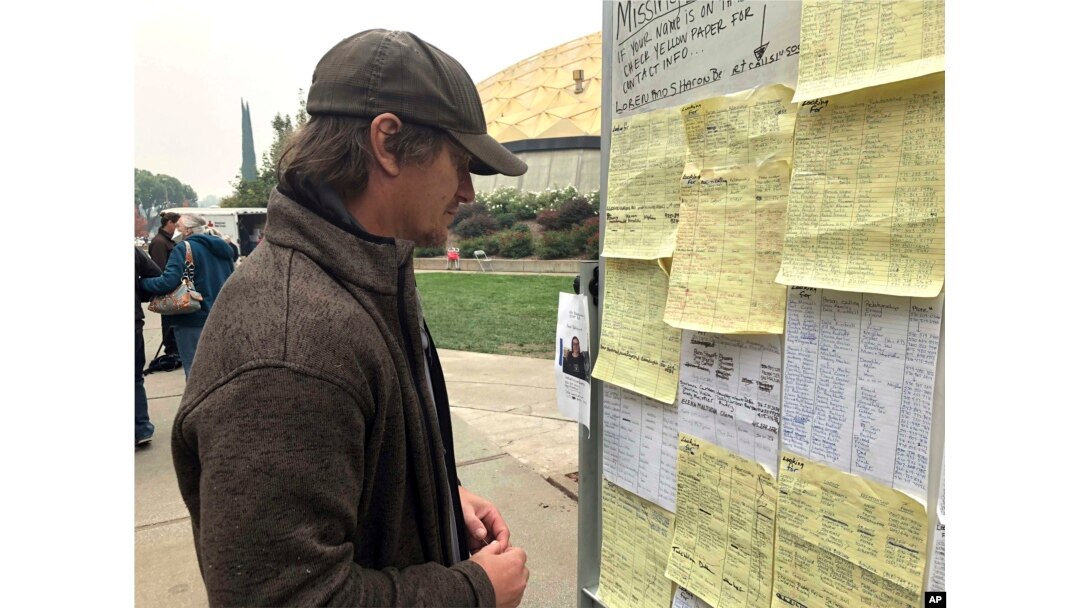 Wildfire evacuee Greg Gibson looks for information about his missing neighbors at The Neighborhood Church in Chico, Calif., Nov. 13, 2018.