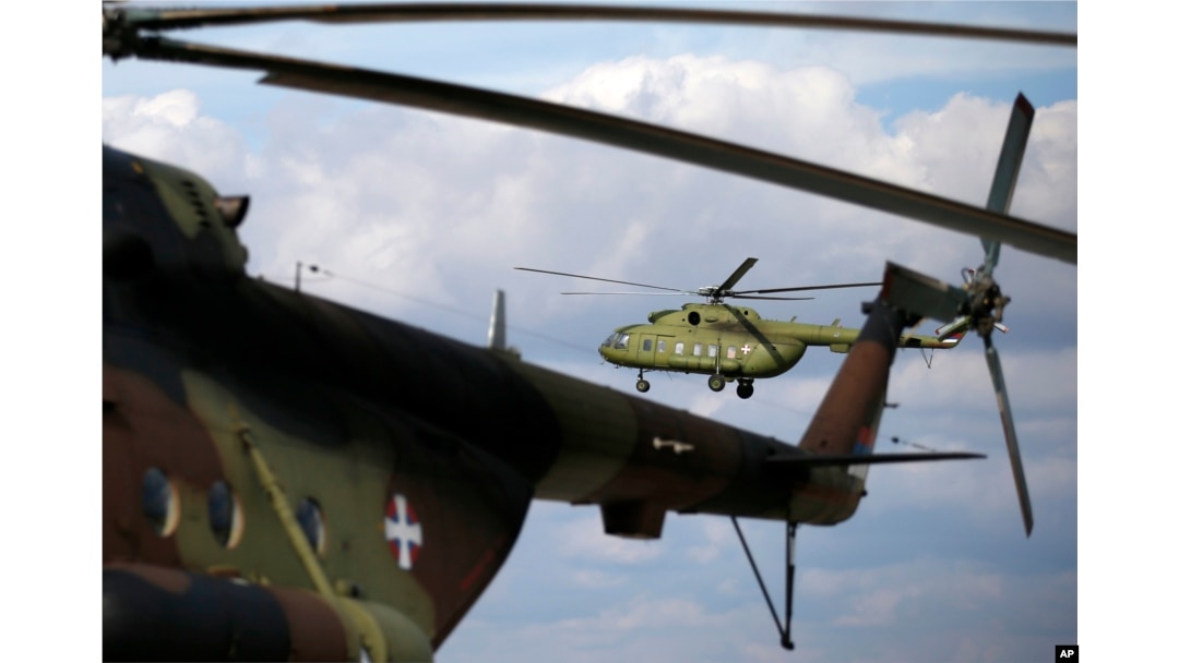 FILE - A Serbian transport helicopter with mixed crew performs during the joint Russian-Serbian military exercises BARS (Brotherhood of Aviators of Russia and Serbia) 2016, at the military airport Batajnica, near Belgrade, Serbia, Oct. 13, 2016.