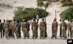 Hassan Hanafi Haji is tied to a wooden post as he is prepared to be executed by firing squad at a police academy in the capital Mogadishu, Somalia Monday, April 11, 2016.