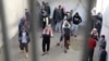 FILE - Prisoners from Iraq and Syria, suspected of being part of the Islamic State, spend time in a prison's outside grounds in Hasaka, Syria, Jan. 11, 2020. 