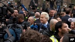 Firebrand int-islam lawmaker Geert Wilders, center, talks to media during his election campaign stop in Spijkenisse, near Rotterdam, Netherlands, Feb. 18, 2017.