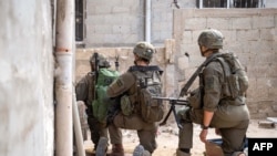 This handout picture released by the Israeli army on June 20, 2024 shows Israeli army soldiers operating in the Gaza Strip amid the ongoing conflict in the Palestinian territory between Israel and Hamas.